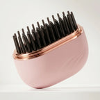 Mini brosse lissante chauffante portable de couleur rose poudré et doré