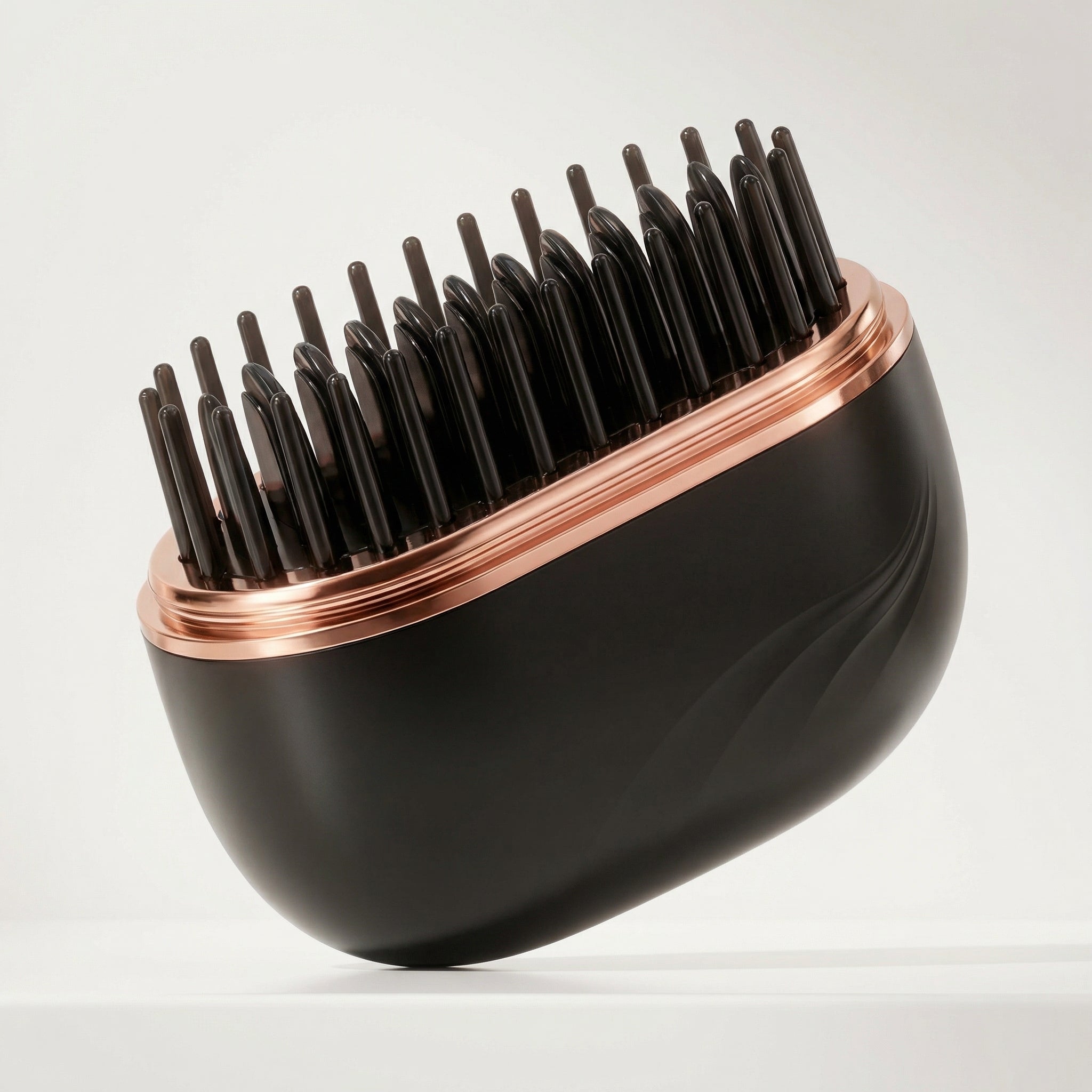 Brosse lissante sans fil Charlyss™ avec plateau en or rose et picots noirs, idéale pour des cheveux parfaitement lissés.